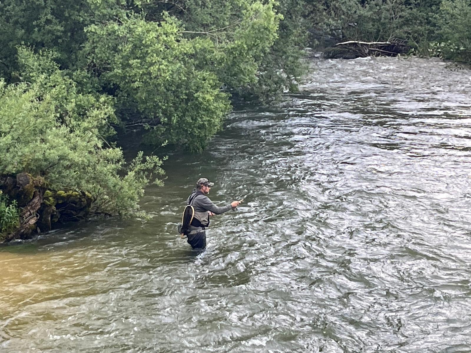 backpack and fishing rod on rock